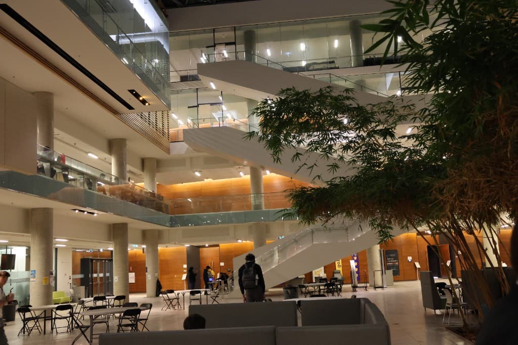 A multi-level university atrium during a community event