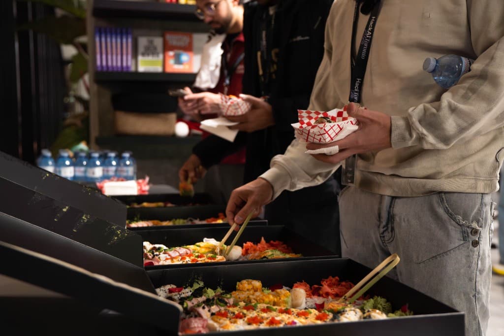 Hackers grabbing sushi at a late-night event buffet