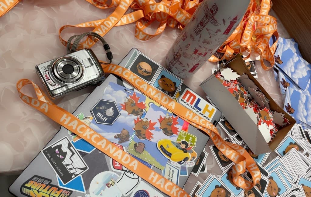 Hackathon stickers, lanyards, and a sticker-covered laptop
